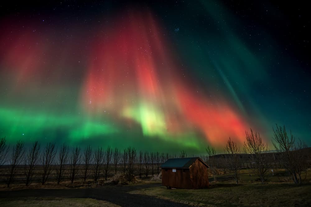Vibrant Northern Lights Cabin by Joško Šimic — canvas wall art