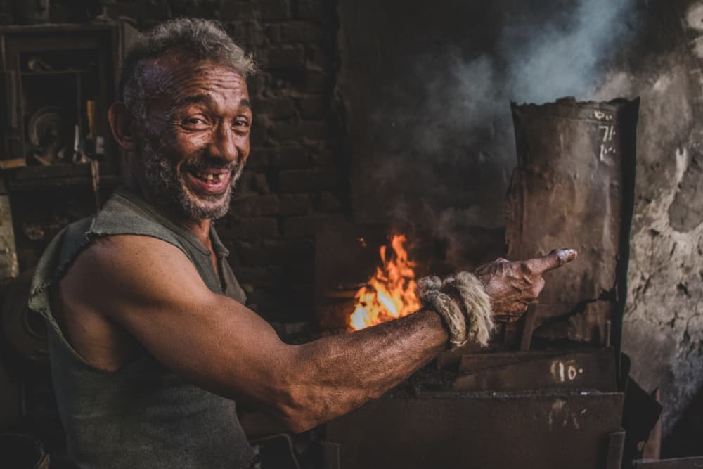 Happy Blacksmith Pointing by Hesham Ragab — canvas wall art