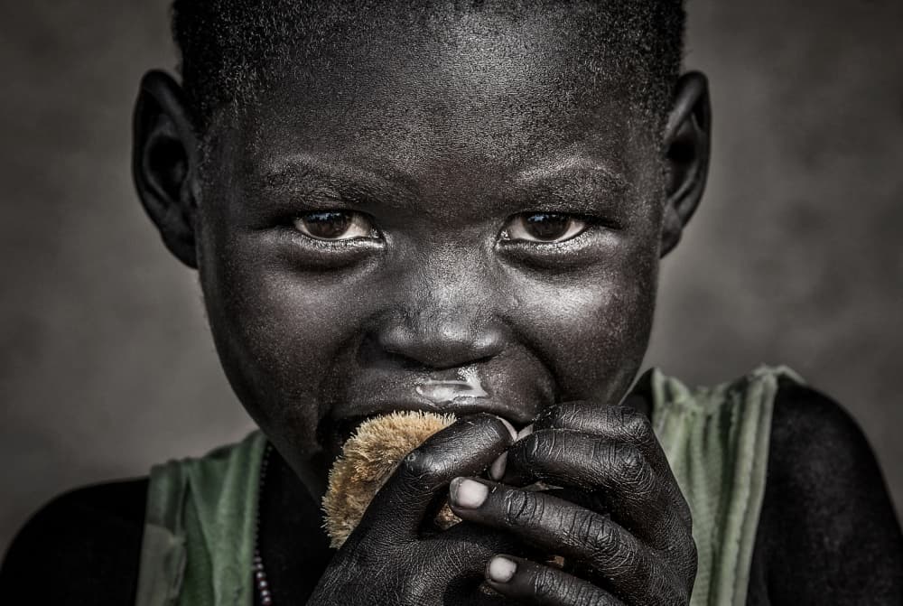 Intense Child Eating by Joxe Inazio Kuesta Garmendia — canvas wall art