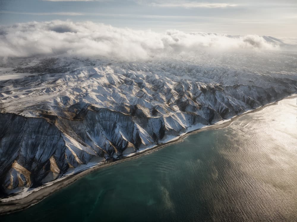 Sunlit Snowy Coastal Mountains by Ivan A. Godovikov — canvas wall art