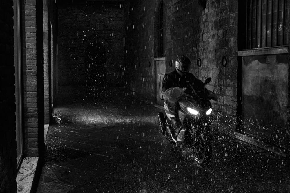Dark Alley Rain Ride by Luca Domenichi — canvas wall art