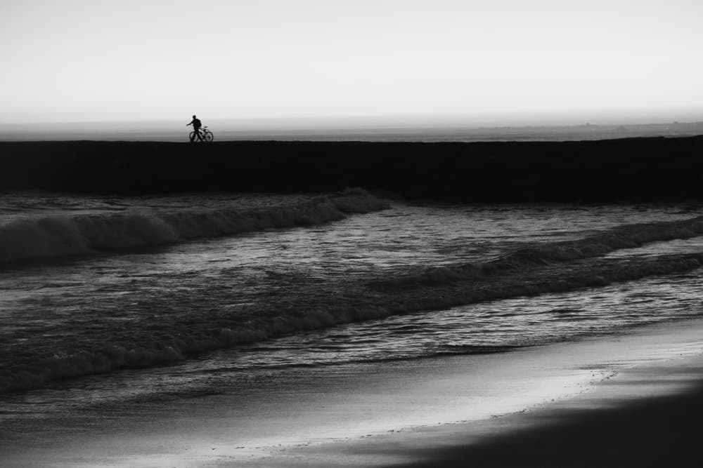 Solitary Ocean Cyclist by Josefina Melo — canvas wall art