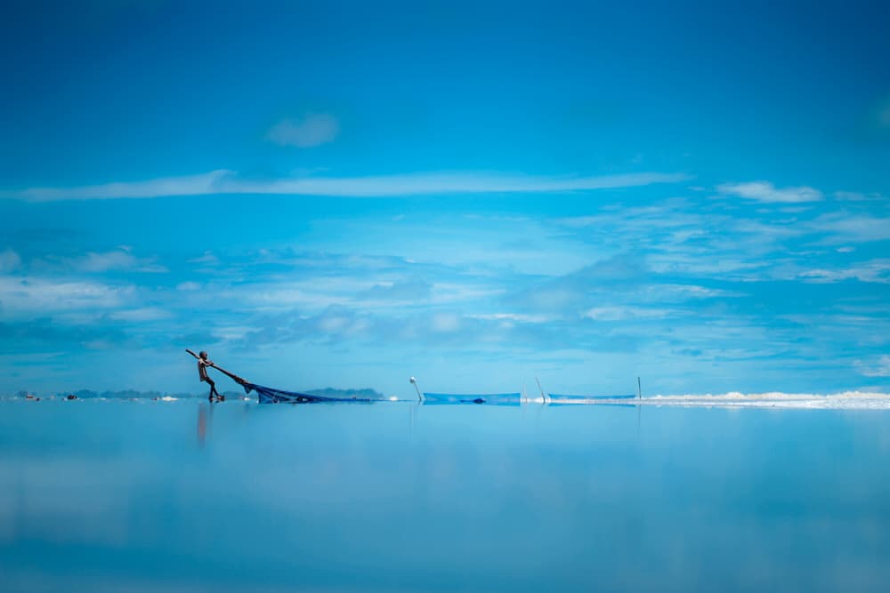 Lone Figure Blue Horizon by Rakibul Alam Khan — canvas wall art