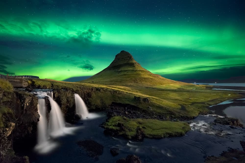 Green Aurora Over Kirkjufell by Carlos Resende — canvas wall art