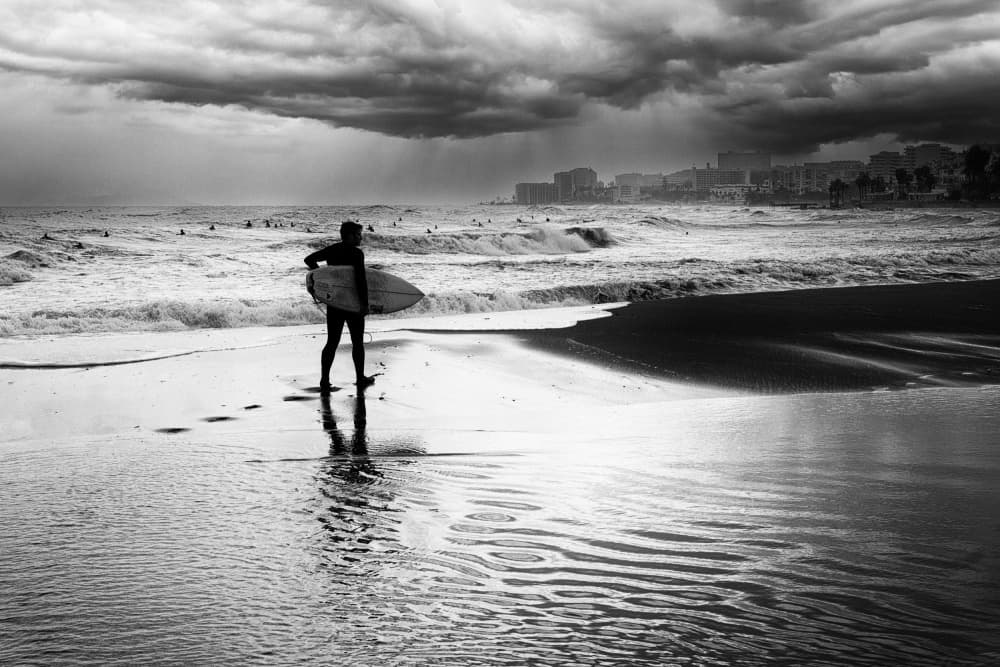 Lone Surfer Stormy Beach by Jurij Bizjak — canvas wall art