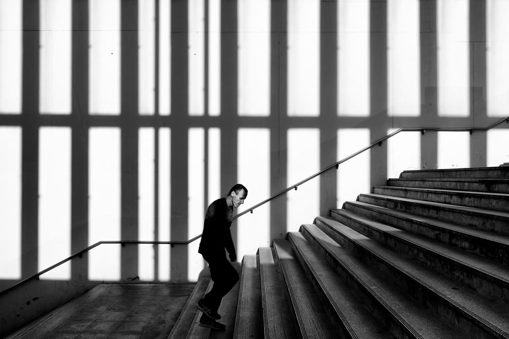 Man on Shadowed Stairs by Carlos Costa — canvas wall art
