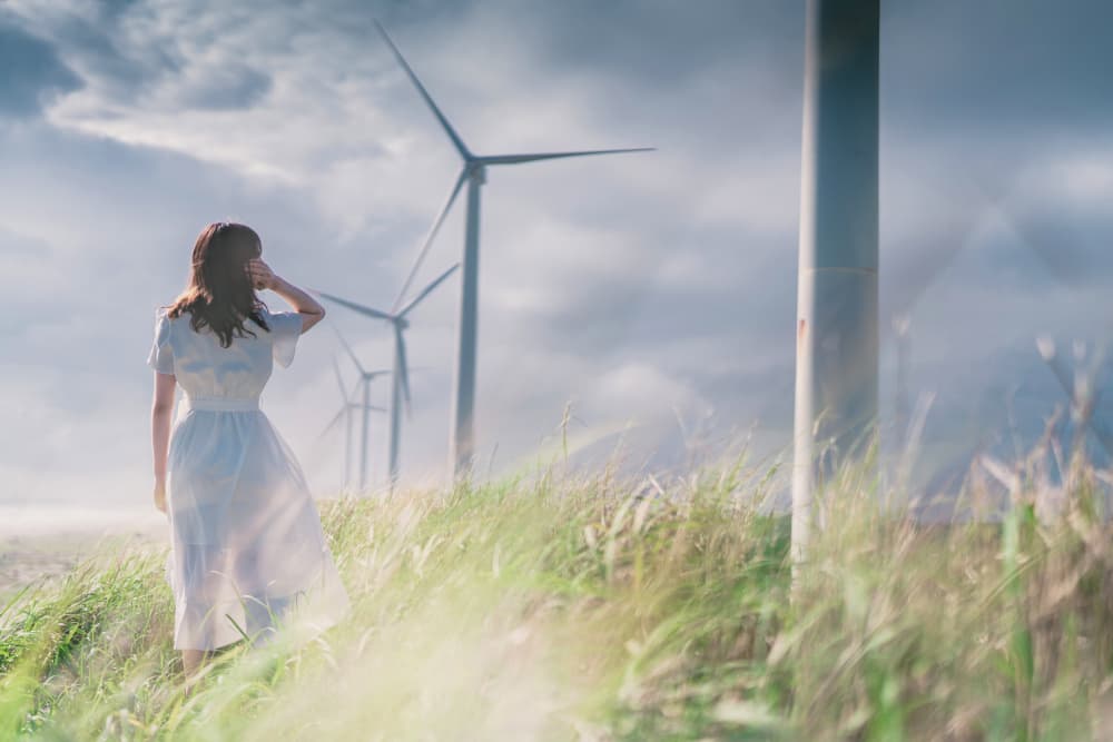 Woman Facing Wind Turbines by HIDASAN — canvas wall art