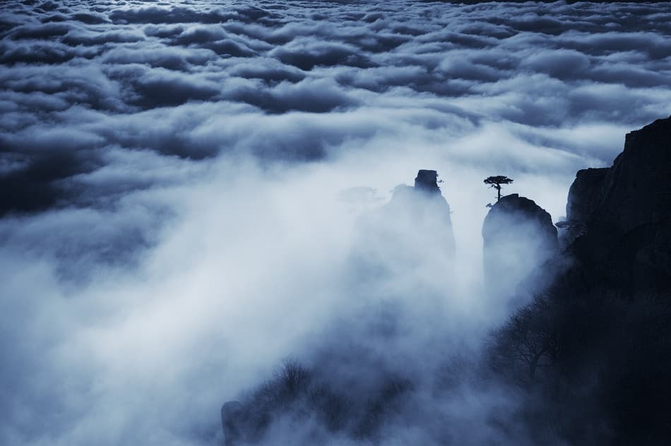Mysterious Peaks Above Clouds by Alexey Kharitonov — canvas wall art