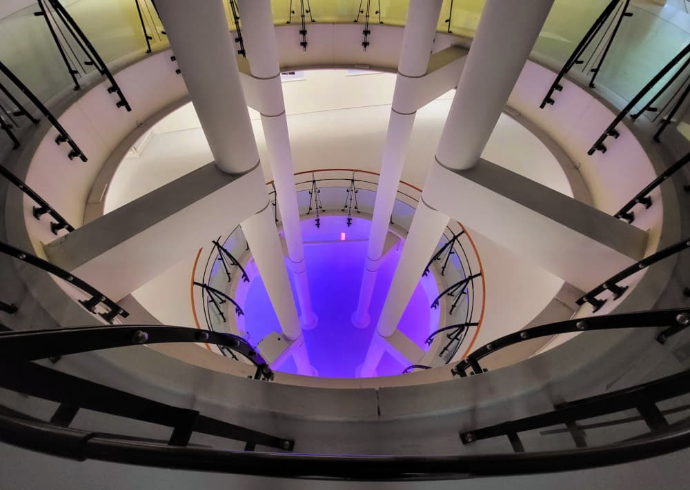 Blue Lit Spiral Staircase by Huib Limberg — canvas wall art
