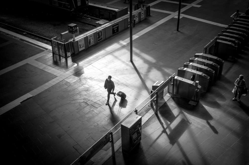 Man in Station Shadows by Allan Li wp — canvas wall art