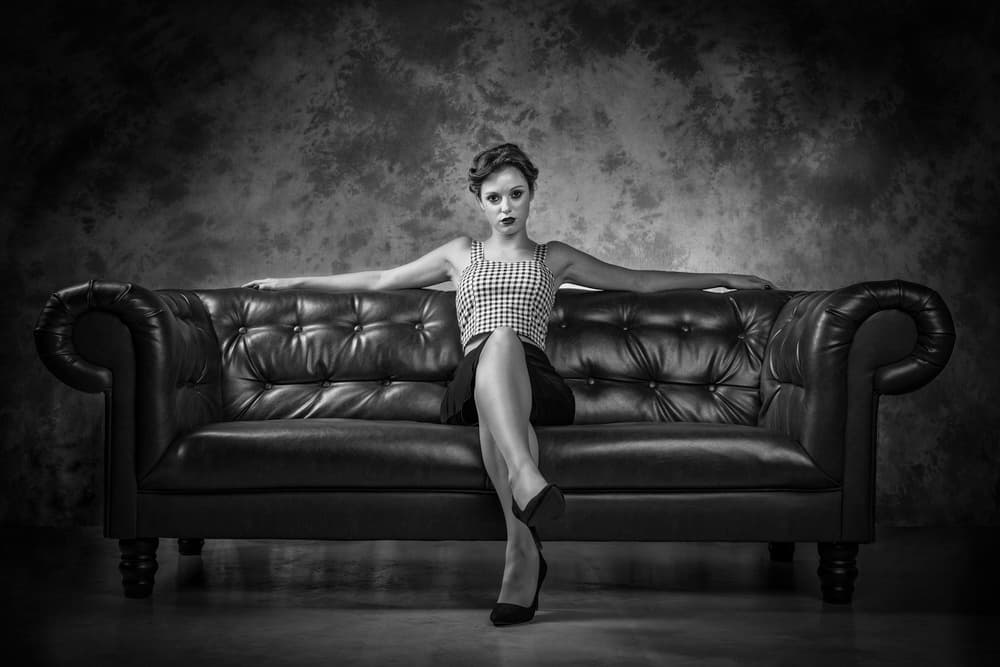 Confident Woman On Sofa by Luc Stalmans — canvas wall art