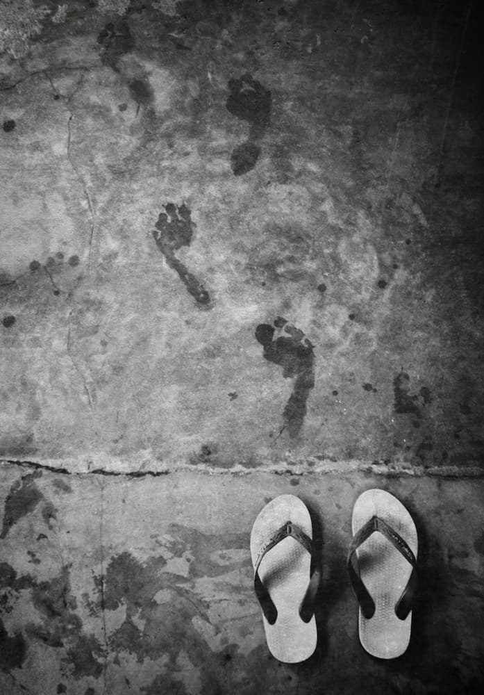 Wet Footprints On Concrete by Kahar Lagaa — canvas wall art