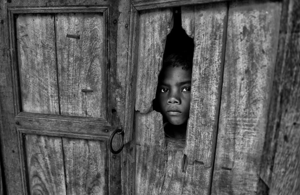 Boy Peeking Through Door by Avishek Das — canvas wall art