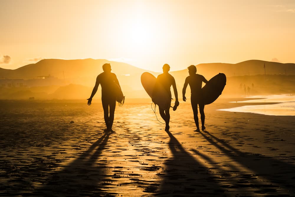 Golden Hour Surfers by Miha Pavlin — canvas wall art