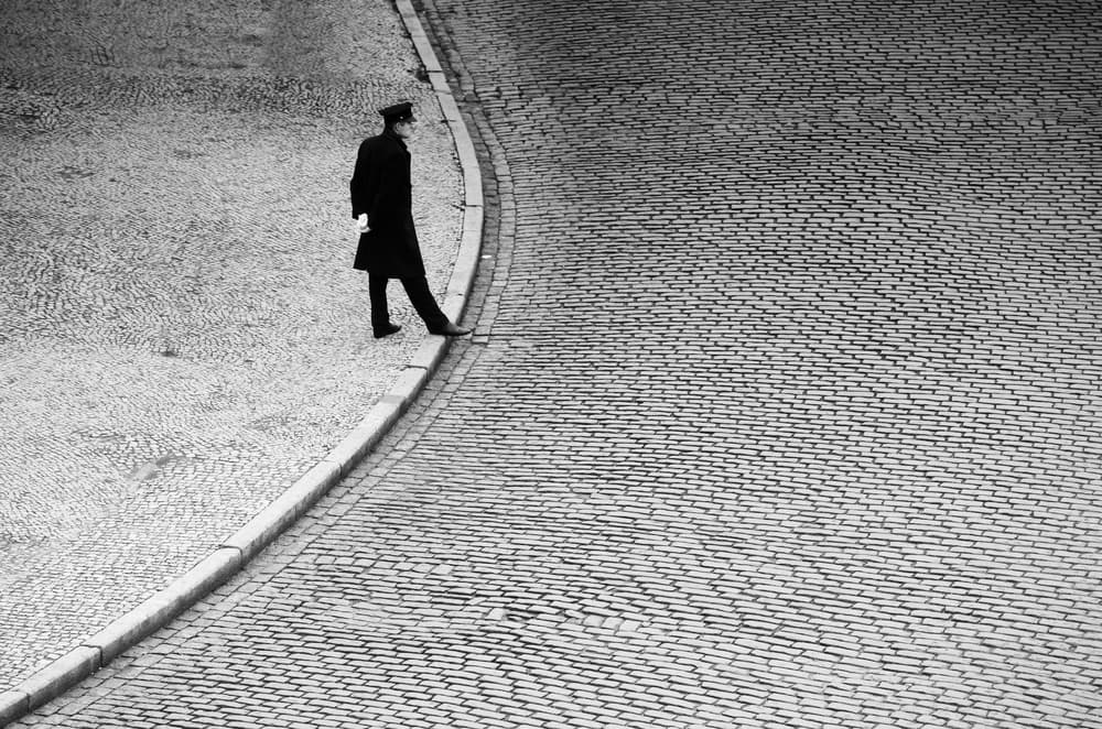 Uniformed Man on Cobblestone by Anna Niemiec — canvas wall art