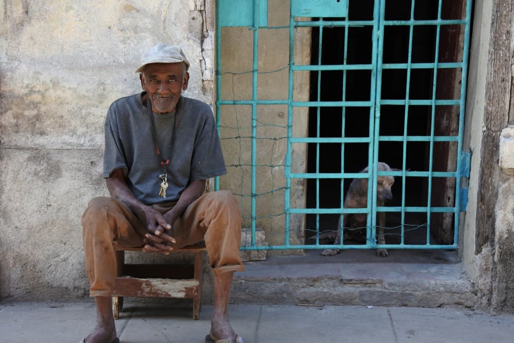 Smiling Man Blue Gate by Eduardo Perez Sanchez — canvas wall art