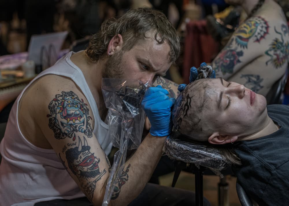 Tattoo Artist At Work by Wendy Fischer Hartman — canvas wall art