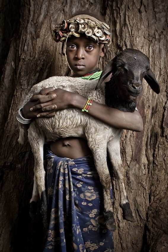 Young Child Holding Lamb by Ben McRae — canvas wall art