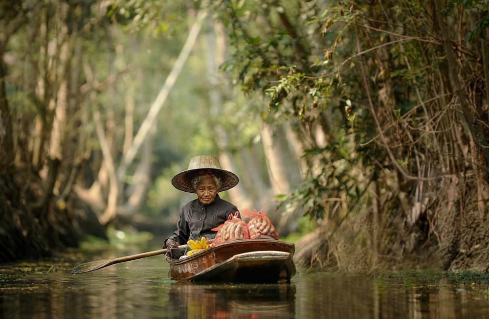 Paddling Through Green Waters by Vichaya — canvas wall art