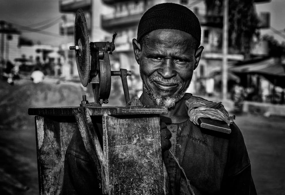 African Artisan Smile by Joxe Inazio Kuesta Garmendia — canvas wall art
