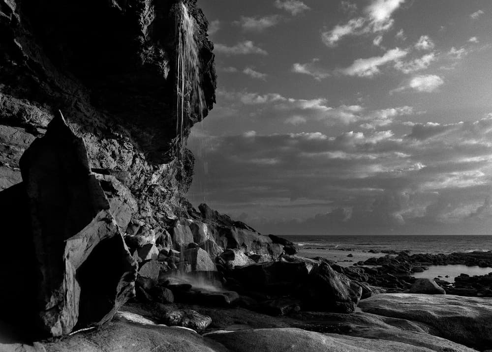 Dramatic Coastal Waterfall by Nana Sousa Dias — canvas wall art