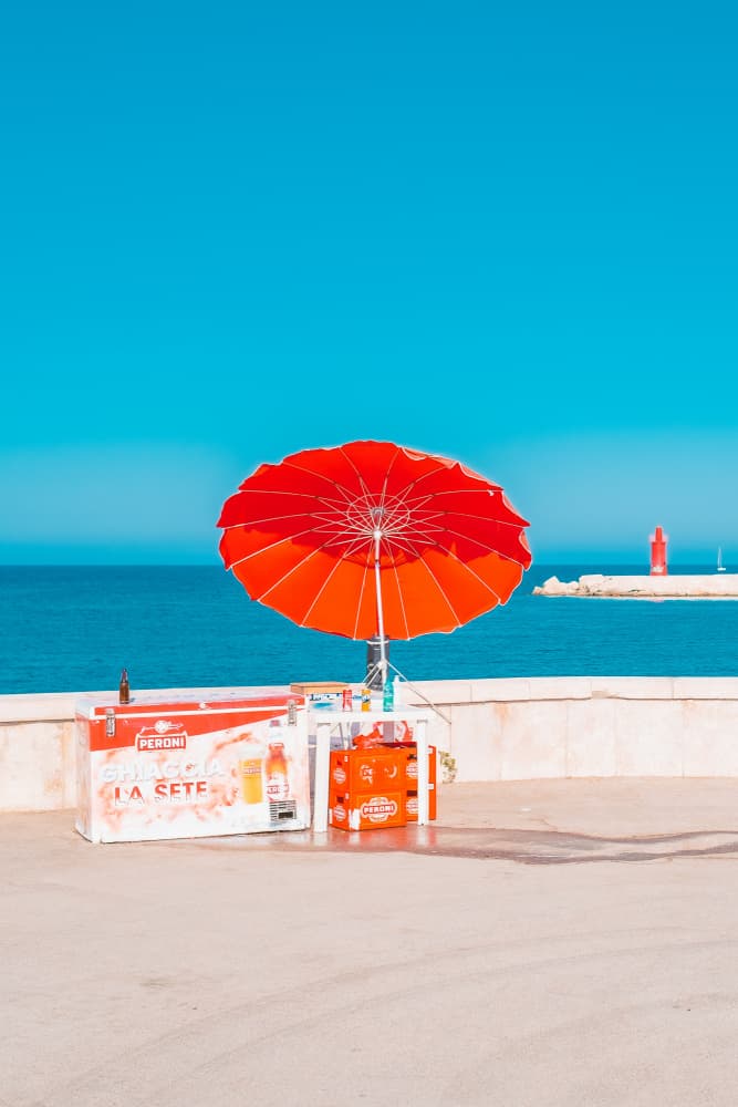 Red Umbrella Ocean View by Roberto Ruoli — canvas wall art