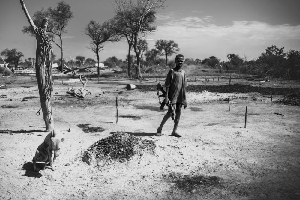 Mundari child with AK47 by Svetlin Yosifov — canvas wall art