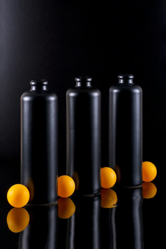 Black Bottles Orange Reflection by Brig Barkow — canvas wall art