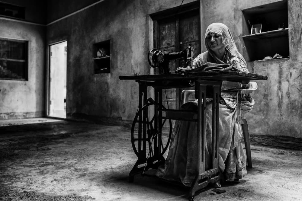 Old Woman Sewing by Mohammed Alnaser — canvas wall art