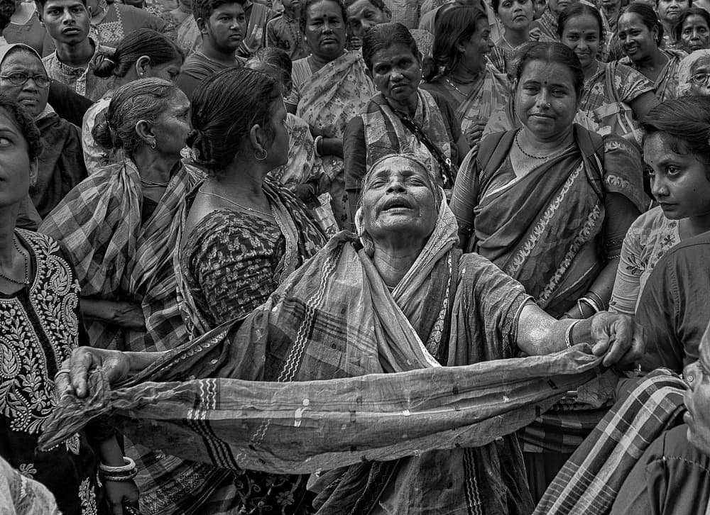 Sorrowful Woman in Crowd by Shaibal Nandi — canvas wall art