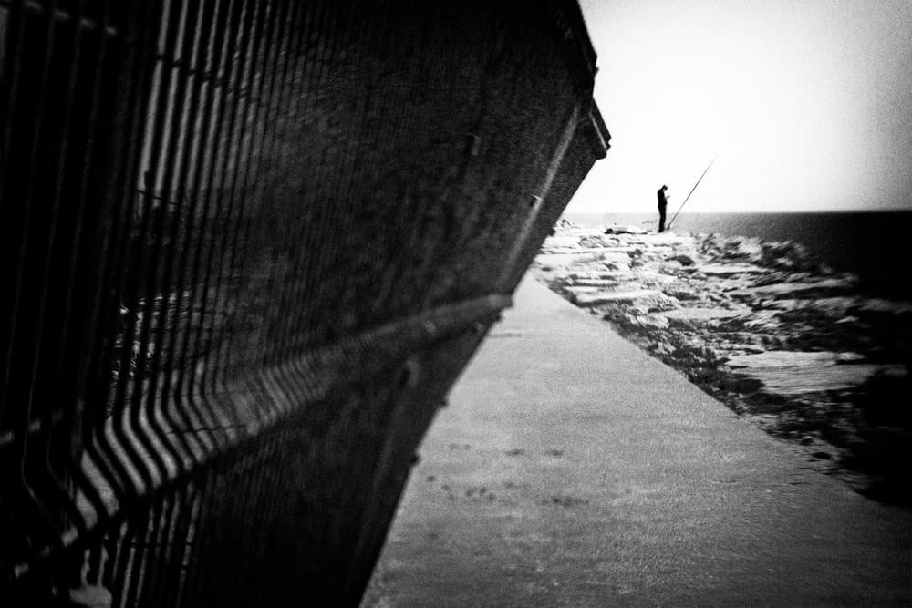Lone Fisherman Ocean View by Laura Mexia — canvas wall art