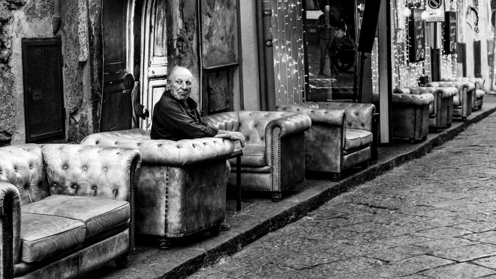 Man Among Street Chairs by Rosario Leonardi — canvas wall art