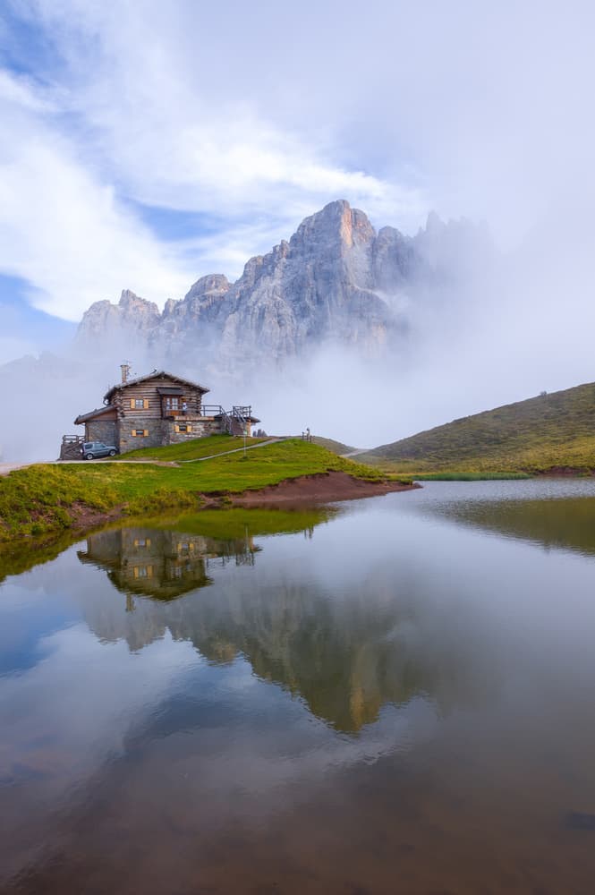 Serene Mountain Lake Hut by Alessandro Traverso — canvas wall art