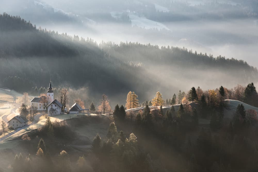 Sunlit Misty Village by Kristjan Rems — canvas wall art