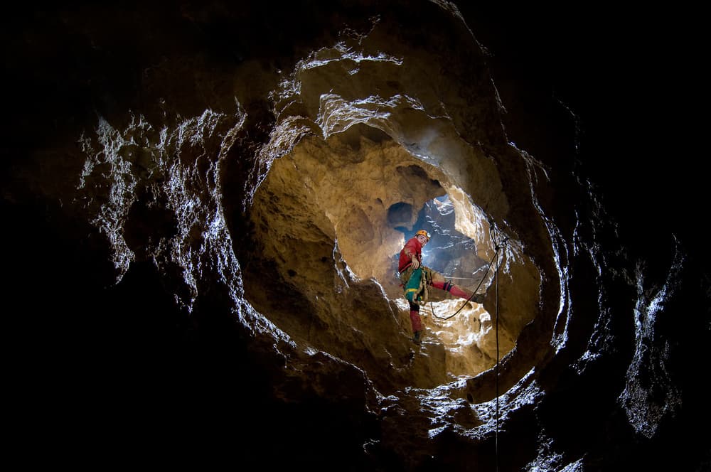Caver in Glowing Cave by Christian Roustan (Kikroune) — canvas wall art