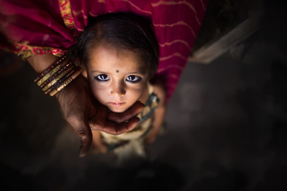 Little Girl's Innocent Gaze by Mohammed Baqer — canvas wall art