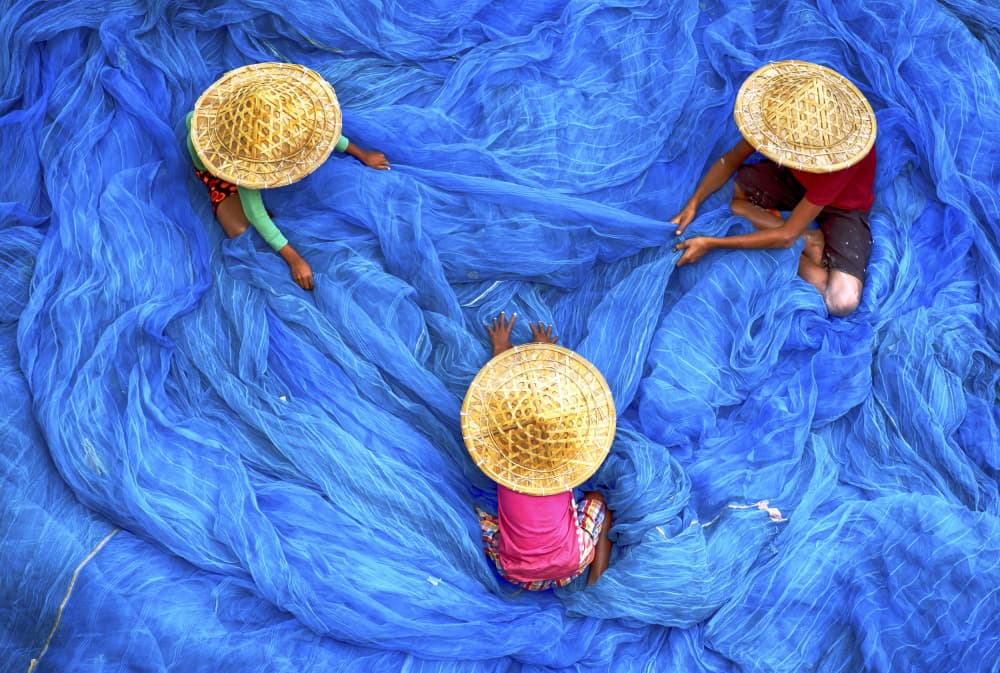 Sorting Blue Fishing Nets by Ajit Kumar Majhi — canvas wall art