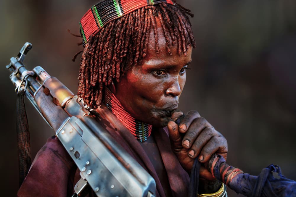 Tribal Woman with Rifle by Irene Perovich — canvas wall art