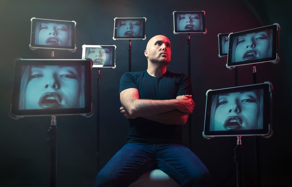 Man Amid Digital Faces by Oren Hayman — canvas wall art
