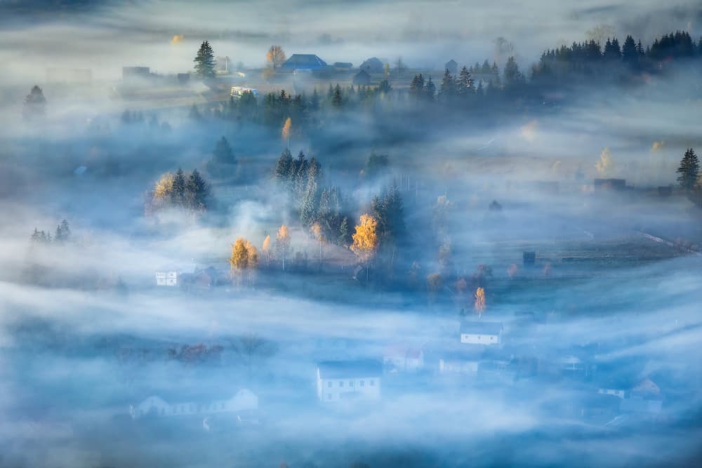 Misty Autumn Village by Sebastian Prioteasa — canvas wall art