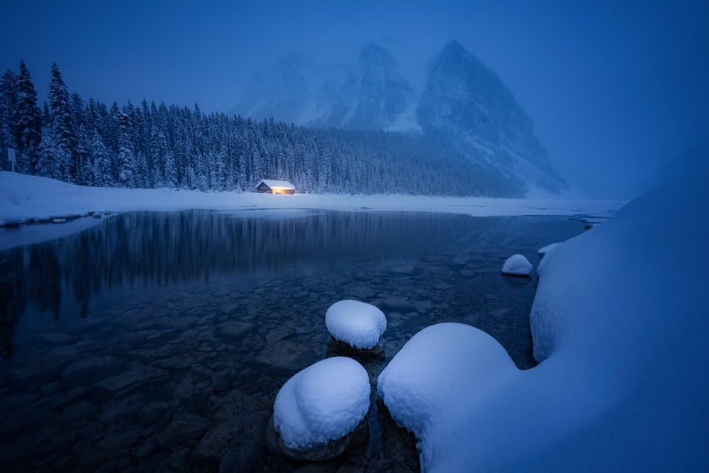 Glowing Cabin Winter Lake by Yongnan Li （李永男） — canvas wall art