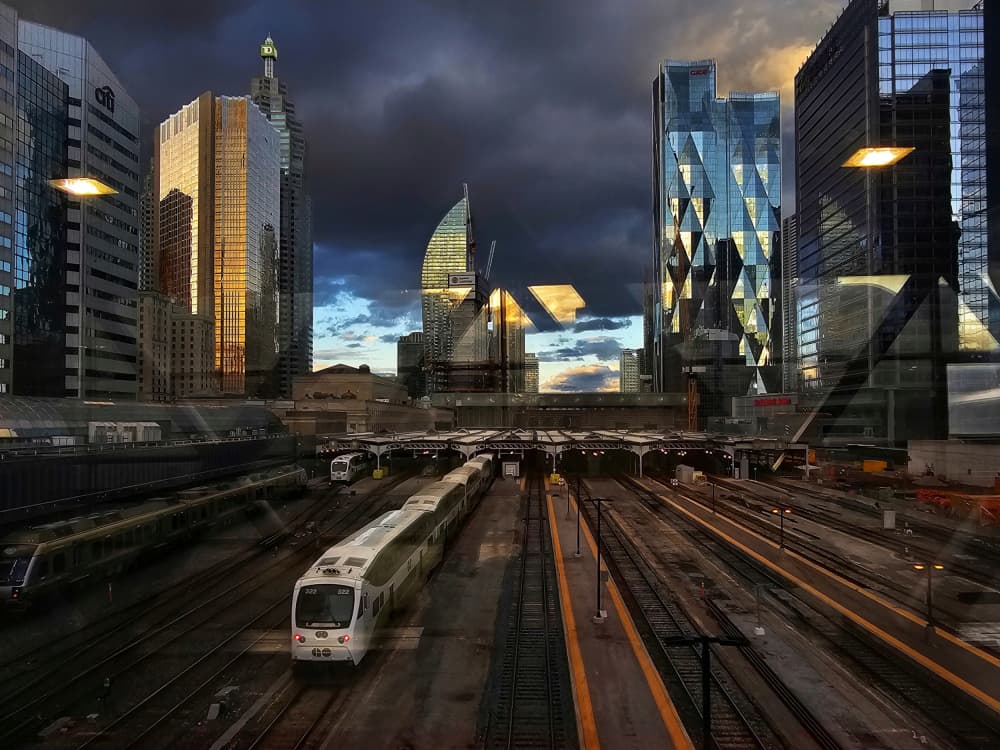 City Trains Under Dramatic Sky by Hui — canvas wall art