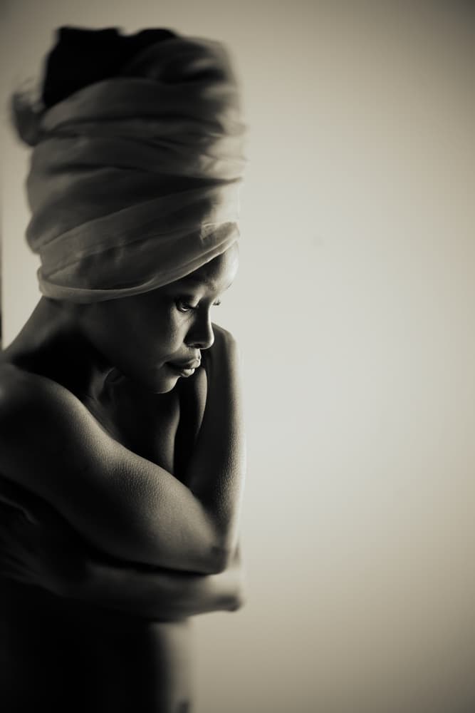 Pensive Woman Headwrap by Mel Brackstone — canvas wall art