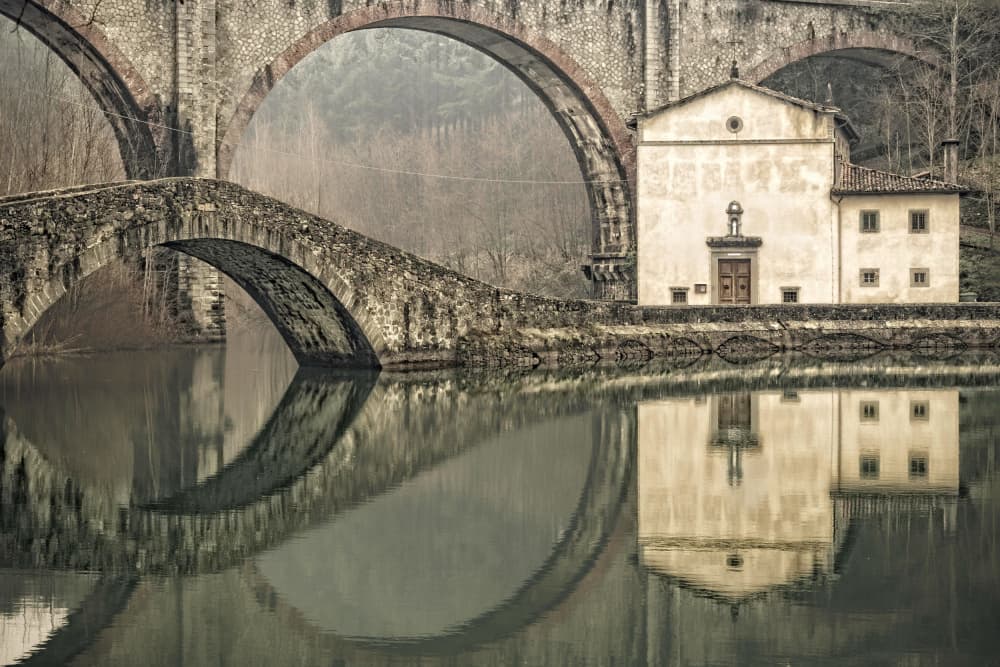 Old Stone Bridge Reflection by Donato Bellomo — canvas wall art