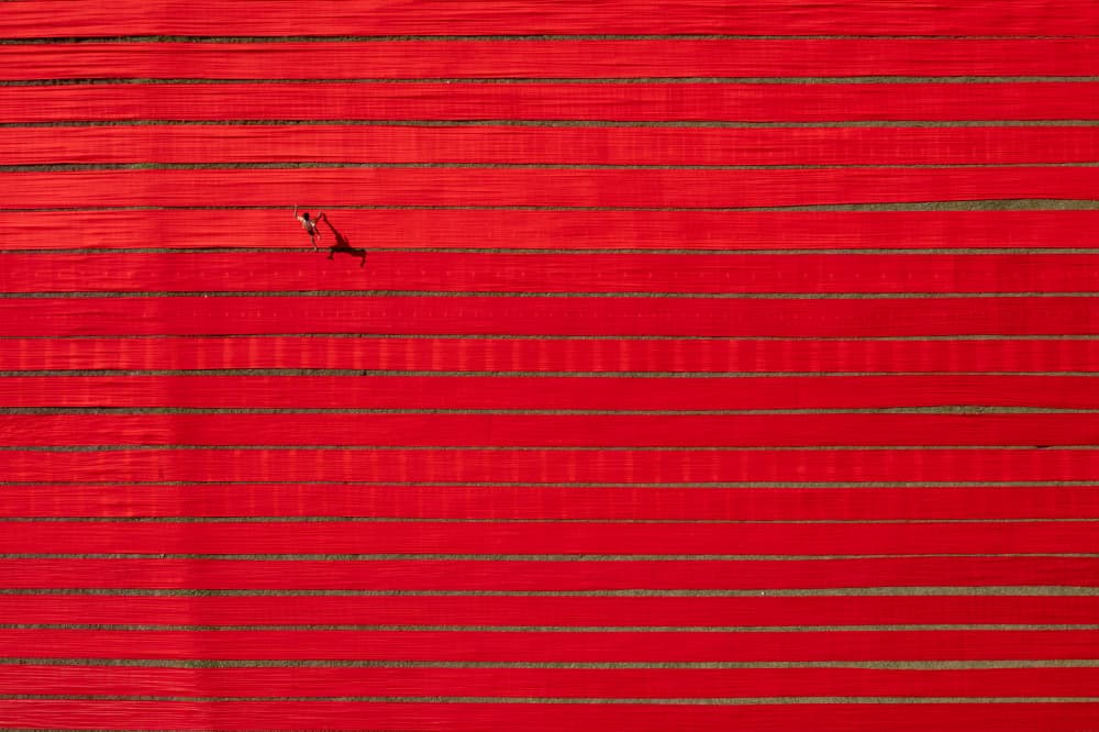Red Field Lone Figure by Azim Khan Ronnie — canvas wall art
