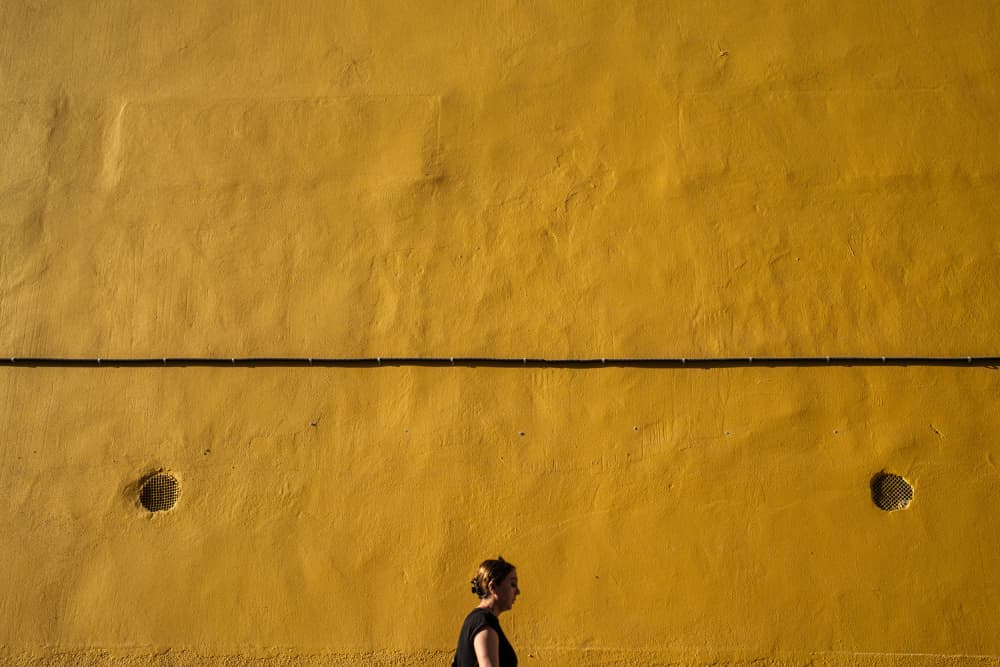 Woman Yellow Wall by Ali Ayer — canvas wall art