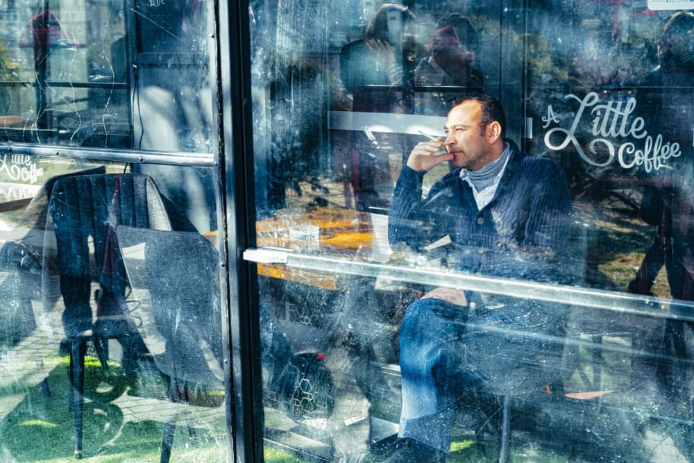 Pensive Man Cafe Reflections by M. Emre Erol — canvas wall art