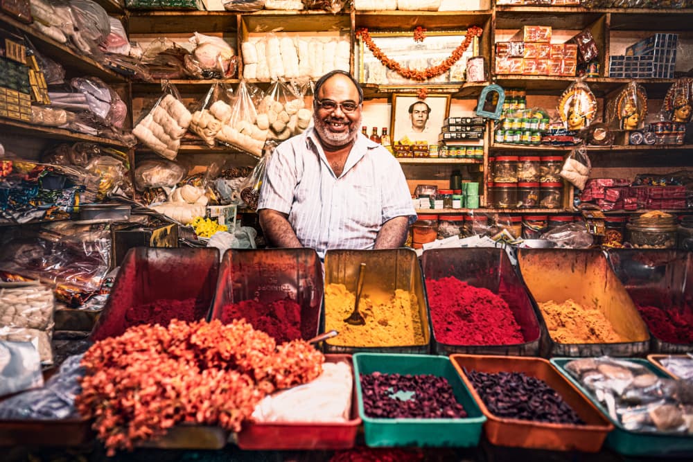Smiling Spice Vendor by Marco Tagliarino — canvas wall art
