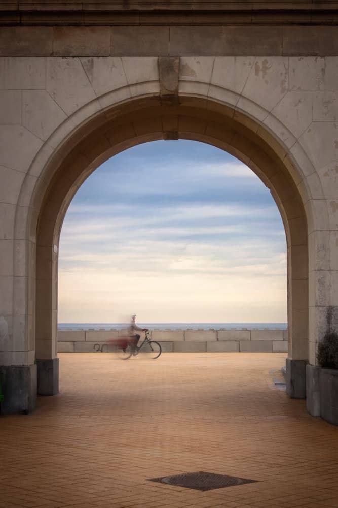 Cyclist Through Archway by Bruno Flour — canvas wall art
