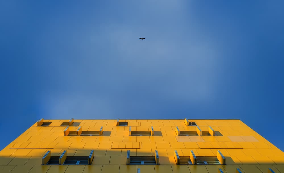 Yellow Building Blue Sky by Fran Osuna — canvas wall art